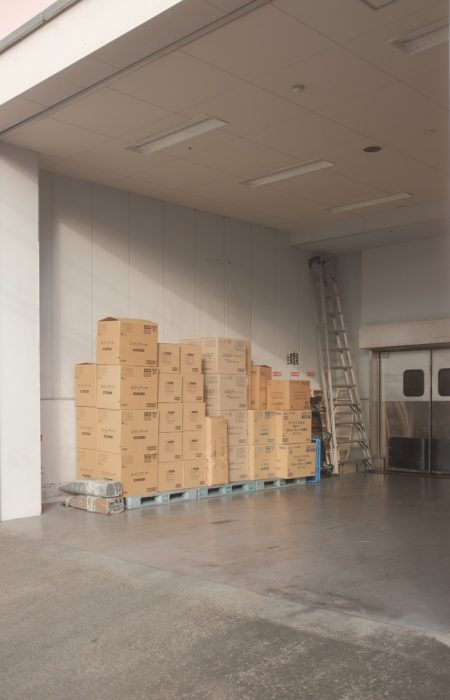 brown cardboard boxes on white floor tiles